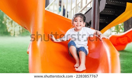 happy asian kids playing slide outdoor playpark for little children leisure for good health 