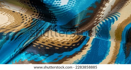 silk fabric. Colors: blue, black, purple, beige. texture, silk panorama, background with beautiful soft blur. Abstraction
