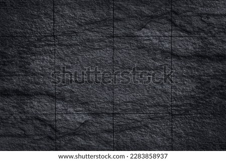 black slate stone wall tile background or texture
