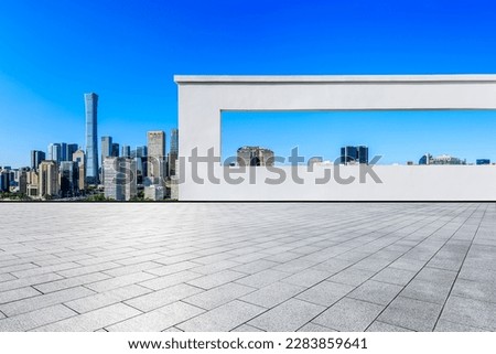 Empty square floors and wall with city skyline in Beijing, China.