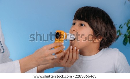 Pediatric pulmonologist helping little boy with aero inhaler. Pulmonologist, medical doctor who specializes in the diagnosis and treatment of diseases and disorders of respiratory system   Royalty-Free Stock Photo #2283866463