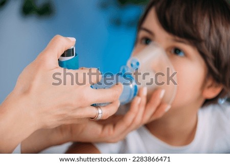 Pulmonologist Helping Little Boy with Aero chamber. Pediatric pulmonologist, medical doctor who specializes in the diagnosis and treatment of diseases and disorders of respiratory system  Royalty-Free Stock Photo #2283866471