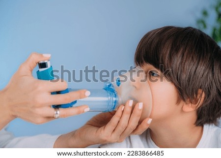 Pulmonologist Helping Little Boy with Aero chamber. Pediatric pulmonologist, medical doctor who specializes in the diagnosis and treatment of diseases and disorders of respiratory system  Royalty-Free Stock Photo #2283866485