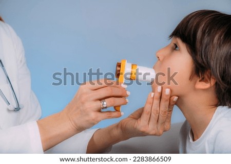 Pediatric pulmonologist measuring lung capacity and force expiratory volume of a boy, spirometer. Pediatric pulmonology, medical discipline specialized in the diagnosis and treatment of diseases and d Royalty-Free Stock Photo #2283866509