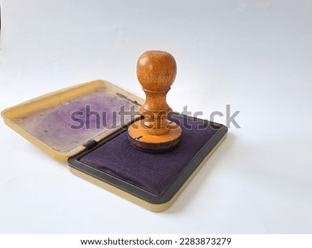 Wooden rubber stamp with ink isolated on white background Royalty-Free Stock Photo #2283873279