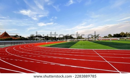 The running track inside a football stadium is usually a circular pathway surrounding the field. Royalty-Free Stock Photo #2283889785