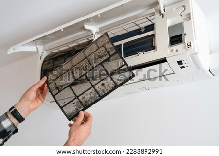 Air conditioner filter dusty. Preparation for maintenance and cleaning. Royalty-Free Stock Photo #2283892991