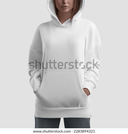 Mockup of white long hoodie on girl with hands in pockets, shirt with side slits, clothes isolated on background, front. Casual clothing template, trendy sweatshirt for design, branding, advertising