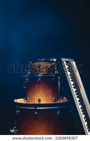 Drums and musical keys on a black background isolated.