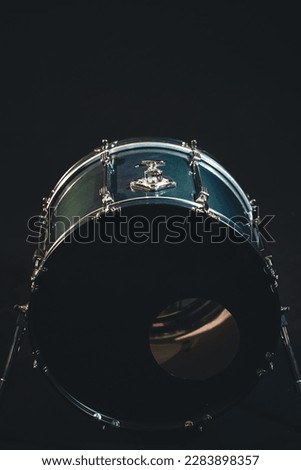 Bass drum, musical instrument on black background.