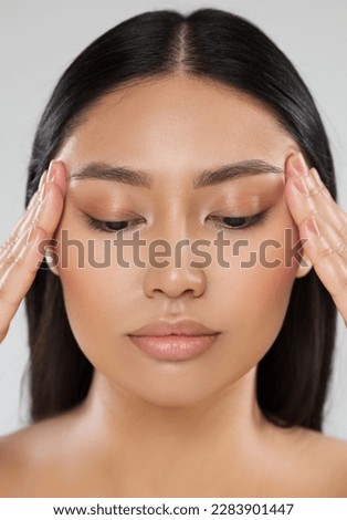 Beauty Woman Closeup Face Lift Massage. Beautiful Asian Model Portrait with Natural Make up. Women Facial Dermal Filler. Eyes Care Cosmetology and Plastic Surgery Royalty-Free Stock Photo #2283901447