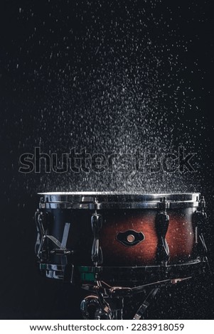 Beautiful snare drum on a black background, close up.