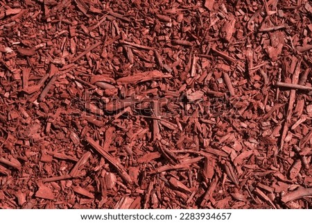 Close-up of an abstract background made of wood shavings and planks painted red. Template for design.