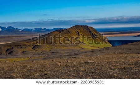 Panoramic over Icelandic Moon Lunar landscape near colorful volcanic caldera Askja, in the middle of volcanic desert in Highlands, blue sky, Iceland, lonely dirt road