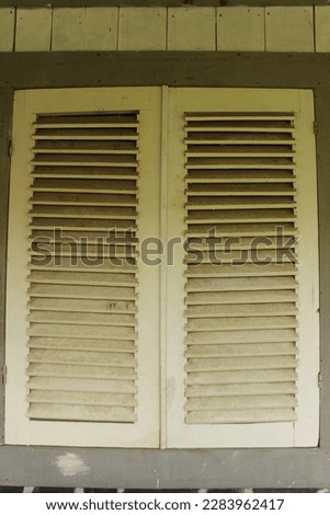 yellow wooden window. looks old and classic