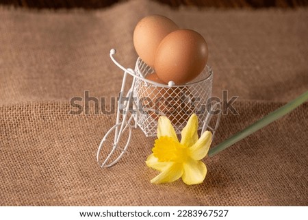 eggs in the basket on the jute background