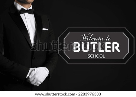 Man in elegant suit and sign Welcome To Butler School on black background
