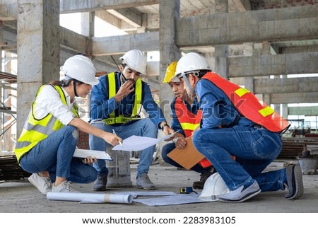 Team of engineer, architect, contractor and foreman meeting and consulting at construction building site with floor plan for real estate development project industry and housing timeline usage Royalty-Free Stock Photo #2283983105