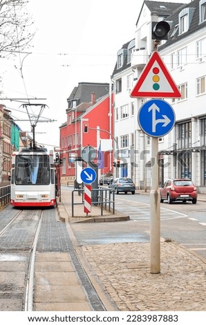 View of city street with tramway and road signs