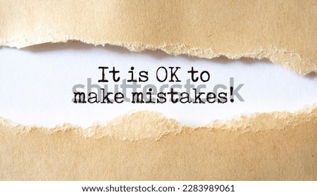 It is OK to make mistakes. Words written under torn paper. Motivation concept text.