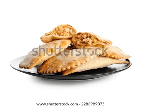 Plate of baked meat empanadas on white background Royalty-Free Stock Photo #2283989375