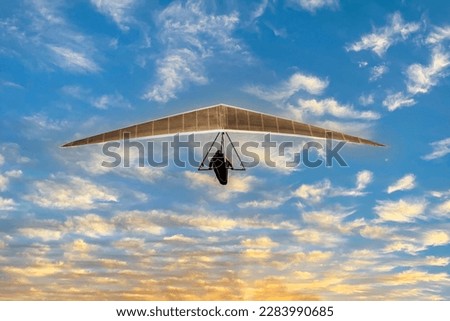 Hang glider flying alone in the sky Royalty-Free Stock Photo #2283990685