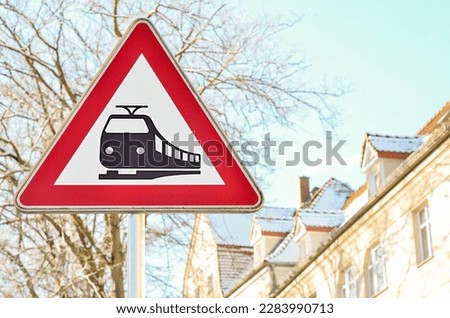 Warning sign for railroad crossing in city, closeup