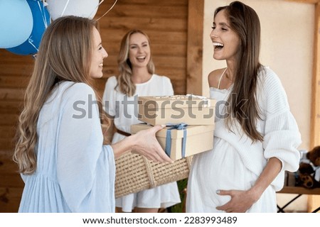 Group of caucasian women giving gifts to friend in pregnant Royalty-Free Stock Photo #2283993489