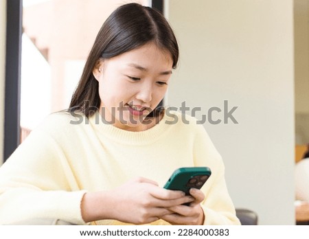 asian pretty woman using a smartphone  at home