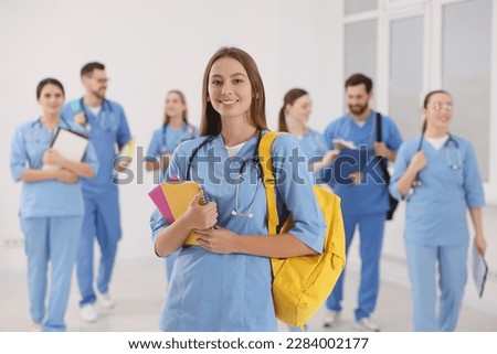 Young medical student with her classmates in university Royalty-Free Stock Photo #2284002177