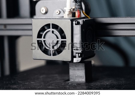 3d printer closeup. Part of 3d printer called extruder. 3D printing technology background. Hotend of printer in work. Printing progress. Small object beeing printed out.