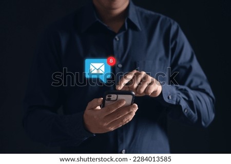 Stay connected with e-mail notifications! A man checks his inbox on his phone, keeping up with work and life on-the-go. Modern technology at its finest. Royalty-Free Stock Photo #2284013585