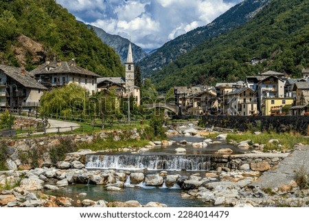 View of alpine river, small town of Fontainemrore and mountains in Aosta Valley, Italy.