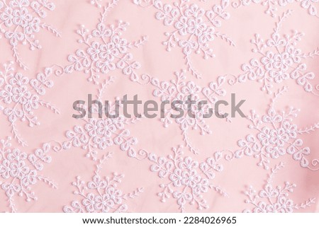 Lace background with colors. abstract lace. floral ornament. white embroidery on delicate pink satin. Royalty-Free Stock Photo #2284026965