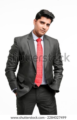 Young indian businessman in classic suit giving expression.