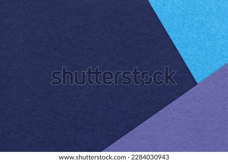 Texture of craft navy blue color paper background with turquoise and violet border. Vintage abstract cardboard. Presentation template and mockup with copy space. Felt backdrop closeup.