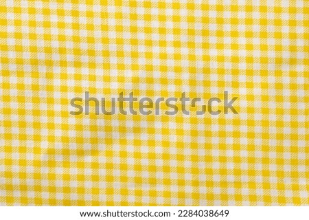 Yellow and white checkered cotton texture. Fabric textile background