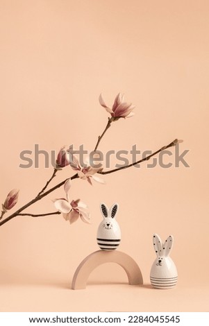  white rabbits with magnolia blossoms on a pink background. Easter or baby background and Banner design elements. Festive picture with place for text