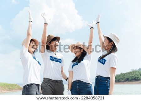 Group of asian diverse people volunteer teamwork joining charity event to cleaning up garbage on public area ,Unity and team spirit on world environment day. Royalty-Free Stock Photo #2284058721