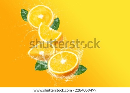 Orange fruit and water splashing isolated on a bright yellow background create a vivid and refreshing image in the mind and eye.
