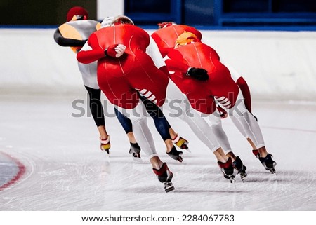 back male skaters running mass start speed skating race, winter sports competition