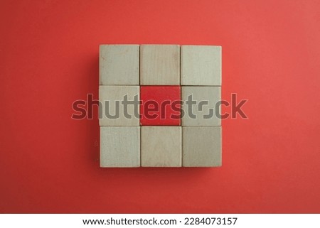 Blank Wooden cubes for put text,logo and infographic stacked in square shape with red blank wooden cube in center on red background use for flat lay top view mock-up item,business and design concept.