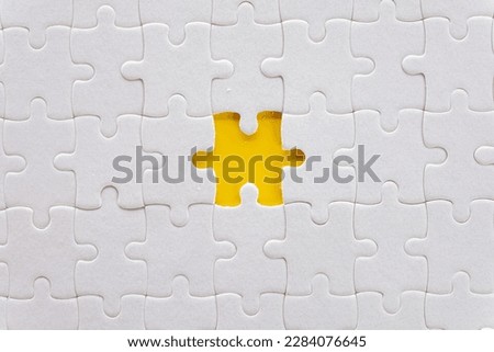 Top view photo of a Missing piece of white jigsaw or puzzle in center over yellow background use for complete,success,idea,finish,goal,business,flat lay top view mock-up item concept.