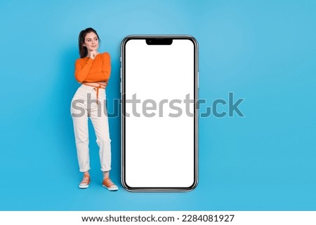 Full body photo of think millennial brunette lady look promo wear top pants sneakers isolated on blue background