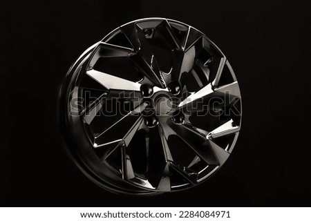 black alloy wheel on black background