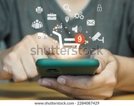 Online shopping and ecommerce technology concept. Selection of products in the basket Wanted product notification through internet technology with safety on smartphones