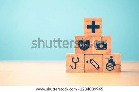 Health care and medical icons print screen on wooden block  for healthy wellness insurance and assurance concept.