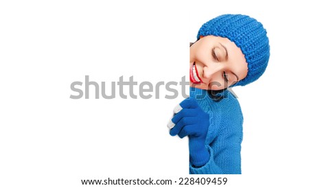 Girl in winter clothes showing a blank banner