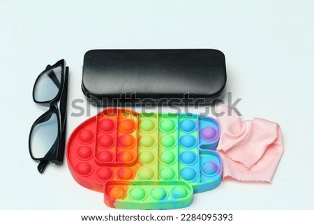 Black grip glasses and colorful sensor toys isolated on white background.Anti stress and relaxation concept.