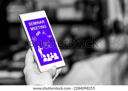 Smartphone screen displaying a seminar meeting concept Royalty-Free Stock Photo #2284098215